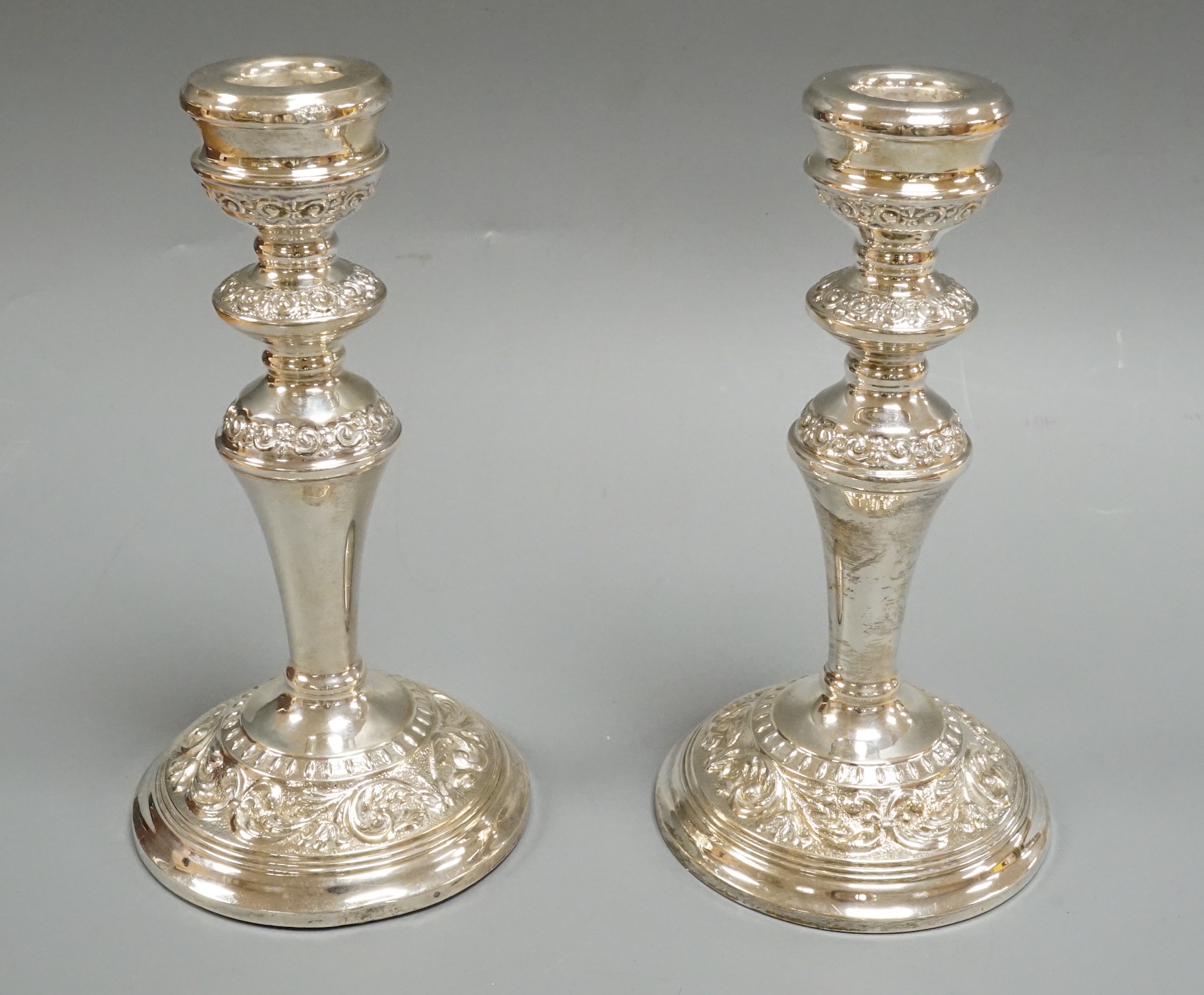 A pair of Elizabeth II silver mounted candlesticks, W.I. Broadway & Co, Birmingham, 1965/66, height 18.9cm.